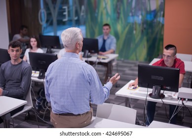 Handsome Mature Teacher And Students In Computer Lab Classroom