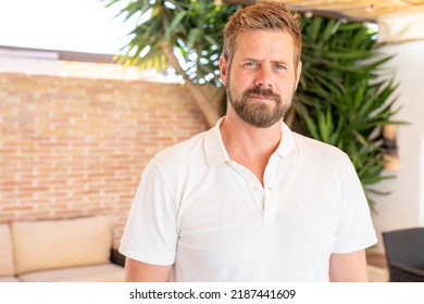 Handsome mid adult man smiling and looking at camera. Portrait of happy young casual man. Close up portrait of caucasian guy standing outdoor. - Powered by Shutterstock