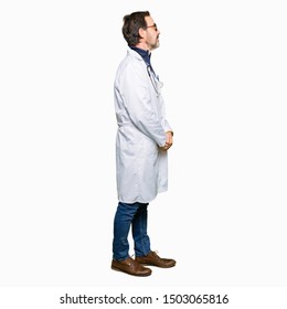 Handsome Middle Age Doctor Man Wearing Medical Coat Looking To Side, Relax Profile Pose With Natural Face With Confident Smile.