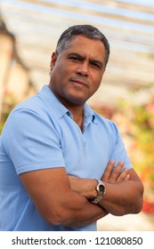 Handsome Middle Age Hispanic Man In Casual Clothing Outdoors.