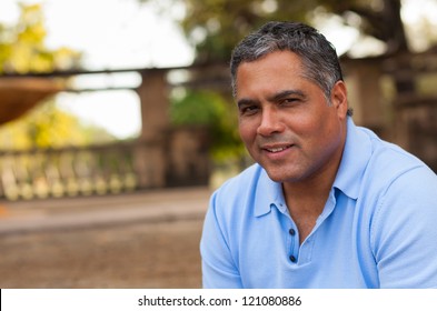 Handsome Middle Age Hispanic Man In Casual Clothing Outdoors.