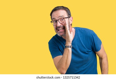Handsome middle age hoary senior man wearin glasses over isolated background hand on mouth telling secret rumor, whispering malicious talk conversation