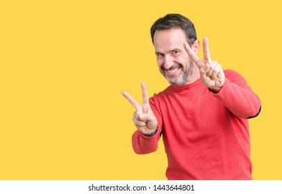 Handsome middle age hoary senior man wearing winter sweater over isolated background smiling looking to the camera showing fingers doing victory sign. Number two. - Shutterstock ID 1443644801