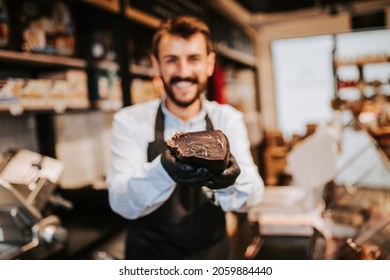 Handsome Middle Age Male Seller Working At Supermarket Or Grocery Store And Selling Cured Meat Products.