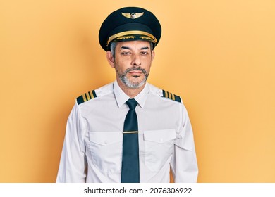 Handsome Middle Age Man With Grey Hair Wearing Airplane Pilot Uniform Looking Sleepy And Tired, Exhausted For Fatigue And Hangover, Lazy Eyes In The Morning. 