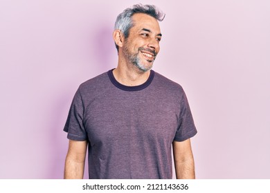 Handsome Middle Age Man With Grey Hair Wearing Casual T Shirt Looking Away To Side With Smile On Face, Natural Expression. Laughing Confident. 