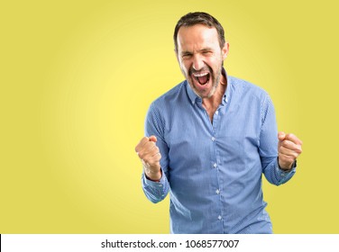 Handsome Middle Age Man Happy And Excited Celebrating Victory Expressing Big Success, Power, Energy And Positive Emotions. Celebrates New Job Joyful