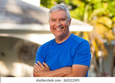 Handsome Middle Age Man Outdoor Portrait In A Home Setting.