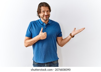 Handsome Middle Age Man Standing Together Over Isolated Background Showing Palm Hand And Doing Ok Gesture With Thumbs Up, Smiling Happy And Cheerful 