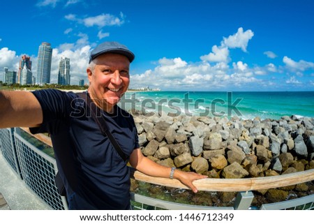 Handsome middle age man taking a selfie while enjoying Miami Beach.