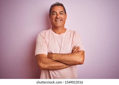 Handsome Middle Age Man Wearing T-shirt Standing Over Isolated Pink Background Happy Face Smiling With Crossed Arms Looking At The Camera. Positive Person.