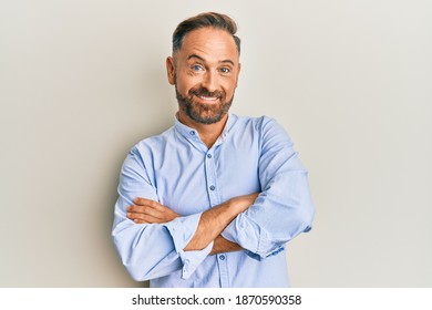 Handsome middle age man wearing business clothes happy face smiling with crossed arms looking at the camera. positive person.  - Shutterstock ID 1870590358