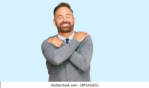 Handsome Middle Age Man Wearing Business Clothes Hugging Oneself Happy And Positive, Smiling Confident. Self Love And Self Care 