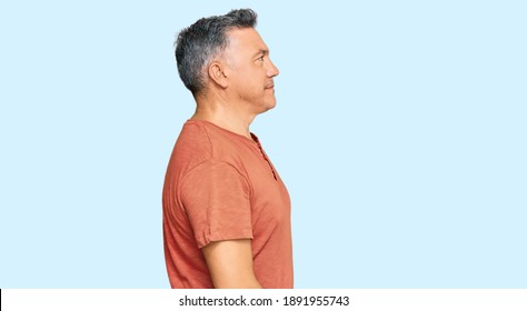 Handsome Middle Age Man Wearing Casual Clothes Looking To Side, Relax Profile Pose With Natural Face With Confident Smile. 