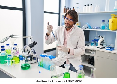 Handsome Middle Age Man Working At Scientist Laboratory Smiling Happy Pointing With Hand And Finger 