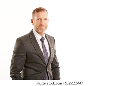 Handsome Middle Aged Businessman Wearing Suit And Looking At Camera While Standing At Isolated White Background With Copy Space. 