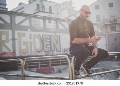 Handsome Middle Aged Man Listening To Music In The City