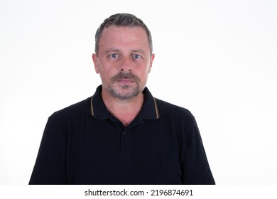 handsome middle aged man looking in camera serious face standing against white background - Shutterstock ID 2196874691
