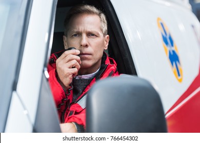 handsome middle aged paramedic talking by portable radio - Powered by Shutterstock