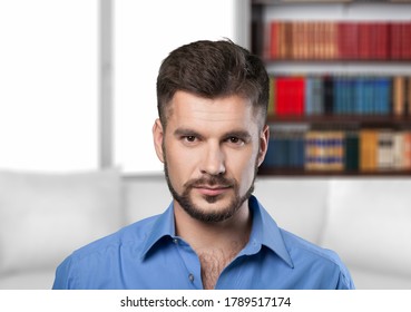 Handsome millennial guy sit on sofa in living room and looks at camera - Shutterstock ID 1789517174