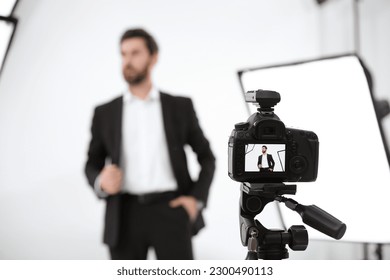 Handsome model posing for camera in modern studio, selective focus. Professional photo session - Powered by Shutterstock