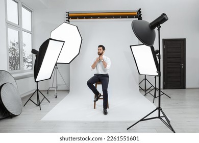 Handsome model posing in modern studio. Professional photo session - Powered by Shutterstock