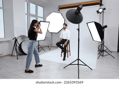 Handsome model posing for professional photographer in studio - Powered by Shutterstock