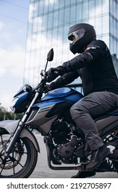 Handsome Motorcyclist On His Moto Riding In The City