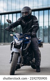 Handsome Motorcyclist On His Moto Riding In The City