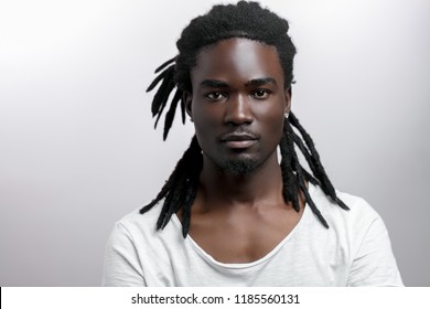 Handsome muscular black man looking camera on white backgound