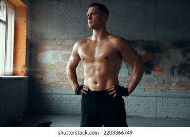 Handsome Muscular Man Holding Hands On Hip While Standing In Gym