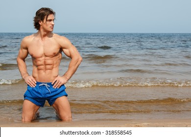 Handsome and muscular man on the beach
