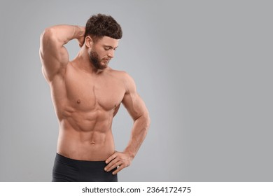 Handsome muscular man on light grey background, space for text. Sexy body