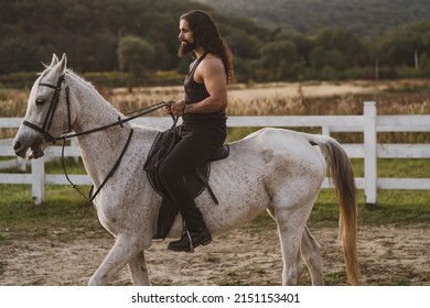 Handsome Muscular Man Riding Horse. Man Ride Horse On Farm. Young Jockey Training His Horse For A Ride.