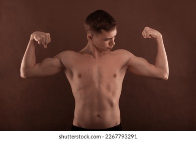 Handsome muscular shirtless adolescent boy flexing muscles. - Powered by Shutterstock