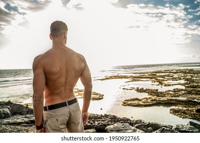 Handsome Muscular Young Man On The Beach Seen From The Back. Summer Vibes.
