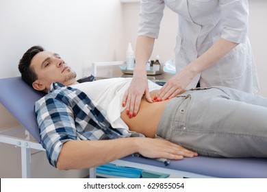 Handsome nice man being examined by the doctor - Powered by Shutterstock