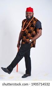 Handsome Nigerian man dressed in Igbo traditional attire and walking stick - Shutterstock ID 1905714532