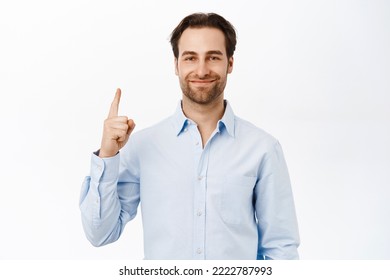 Handsome Office Worker, Man In Blue Collar Shirt, Pointing Finger Up, Showing Advertisement, Company Banner On Top, White Background.