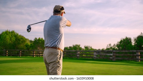 Handsome Older Golfer Swinging Golf Club, Golfing In Paradise.