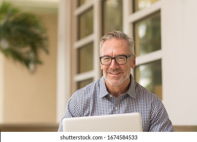 Handsome Older Man Working On The Computer