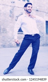 Handsome Passionate Man Dancing Alone Outdoors Against Old Stone Castle