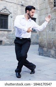 Handsome Passionate Man Dancing Alone Outdoors Against Old Stone Castle