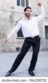 Handsome Passionate Man Dancing Alone Outdoors Against Old Stone Castle