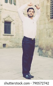 Handsome Passionate Man Dancing Alone Outdoors Against Old Stone Castle