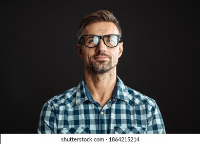 Handsome Pleased Man In Eyeglasses Posing And Looking Upward Isolated Over Black Background