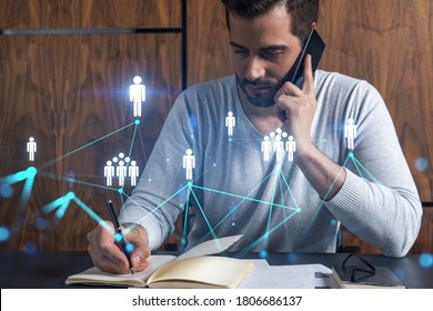 Handsome PR manager in casual wears, speaking phone, taking notes at office try to solve recruitment chalenge from customer. Double exposure. The concept of worldwide hiering in any industry.