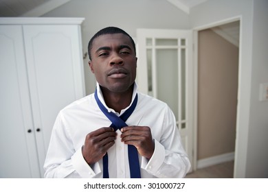 Handsome Professional African Black Man Getting Ready Morning Routine Shirt And Tie At Home For Work