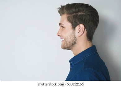 Handsome Profile Portrait Of Young Smiled Man. Attractive Man Side Look Isolated On Grey Background