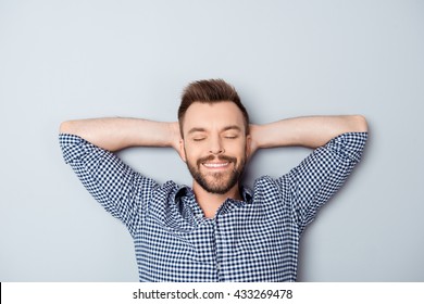 Handsome relaxed man with closed eyes resting after long day